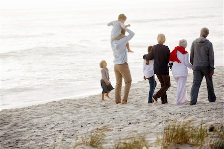 extended family walking outdoors - Multi-generation family walking on the beach Stock Photo - Premium Royalty-Free, Code: 6108-05871523