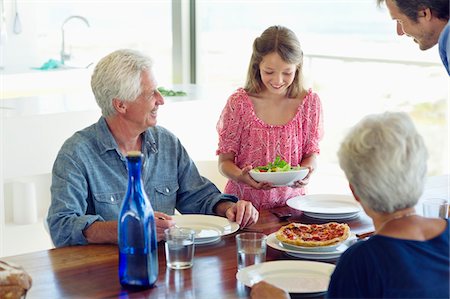 family dining room table - Multi generation family eating food at a dining table Stock Photo - Premium Royalty-Free, Code: 6108-05871538