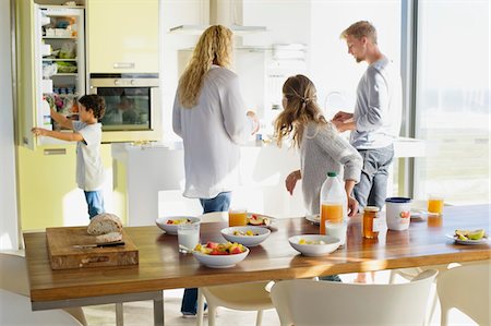 family dining room table - Couple with their two children preparing food at a domestic kitchen Stock Photo - Premium Royalty-Free, Code: 6108-05871690