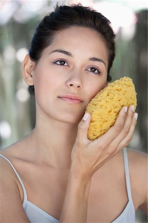 simsearch:6108-05872743,k - Beautiful young woman holding a bath sponge on her face Stock Photo - Premium Royalty-Free, Code: 6108-05871750