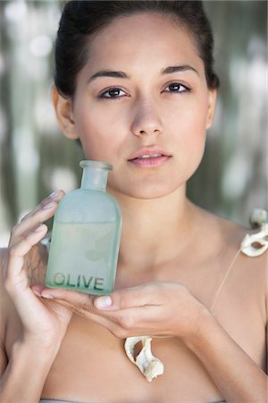 simsearch:6108-05872743,k - Portrait of a beautiful young woman holding bottle of olive oil Stock Photo - Premium Royalty-Free, Code: 6108-05871760