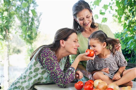 Multi generation family smelling tomatoes Stock Photo - Premium Royalty-Free, Code: 6108-05871777