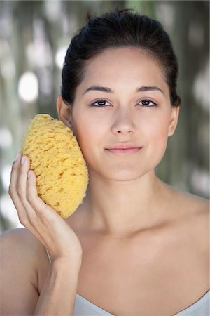 simsearch:6108-05872743,k - Beautiful young woman holding a bath sponge on her face Stock Photo - Premium Royalty-Free, Code: 6108-05871704