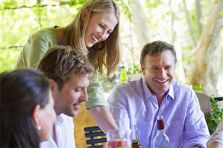 Happy family having drink at house Stock Photo - Premium Royalty-Free, Code: 6108-05871955