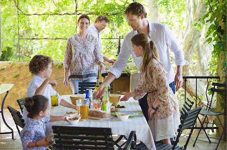 simsearch:6108-07969525,k - Family preparing for food at house Stock Photo - Premium Royalty-Free, Code: 6108-05871905