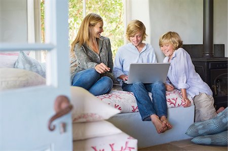 Children and their mother using laptop at house Stock Photo - Premium Royalty-Free, Code: 6108-05872071