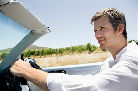simsearch:6108-06906290,k - Mid adult man driving a convertible car Stock Photo - Premium Royalty-Free, Code: 6108-05872184