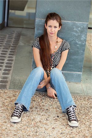 Portrait of a woman sitting on floor Stock Photo - Premium Royalty-Free, Code: 6108-05872128