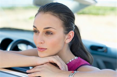 simsearch:6108-06906290,k - Young woman leaning on car window Stock Photo - Premium Royalty-Free, Code: 6108-05872252