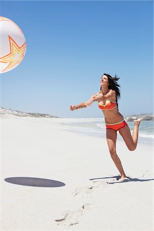 simsearch:6108-05872432,k - Woman playing with beach ball Stock Photo - Premium Royalty-Free, Code: 6108-05872443