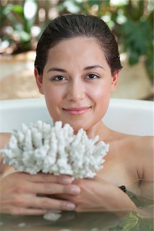 simsearch:6108-05872743,k - Portrait of a beautiful young woman holding bath sponge in a bathtub Stock Photo - Premium Royalty-Free, Code: 6108-05872775