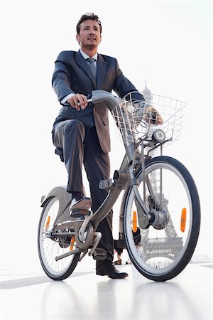 dress shoes for men - Businessman riding a bicycle with the Eiffel Tower in the background, Paris, Ile-de-France, France Stock Photo - Premium Royalty-Free, Code: 6108-05872881