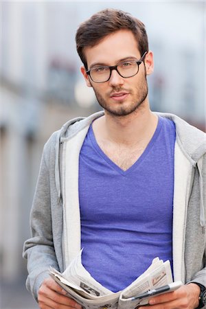 Portrait of a man holding a newspaper, Paris, Ile-de-France, France Stock Photo - Premium Royalty-Free, Code: 6108-05873020