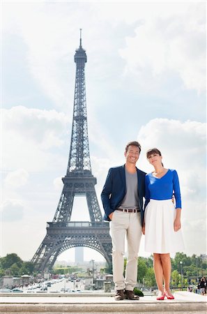 eiffel tower - Couple standing together with the Eiffel Tower in the background, Paris, Ile-de-France, France Stock Photo - Premium Royalty-Free, Code: 6108-05873146