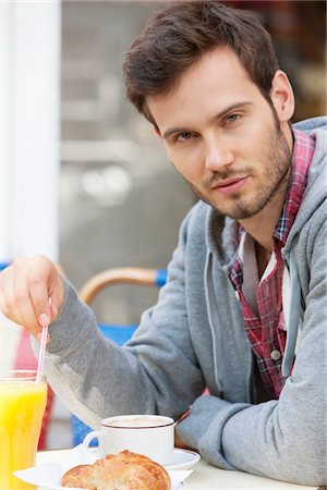 Man sitting at a sidewalk cafe and thinking, Paris, Ile-de-France, France Stock Photo - Premium Royalty-Free, Code: 6108-05873252