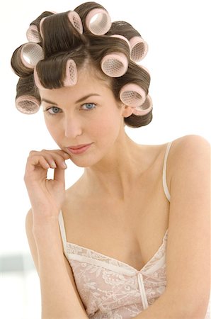 Portrait of a young woman in curlers Stock Photo - Premium Royalty-Free, Code: 6108-05873442