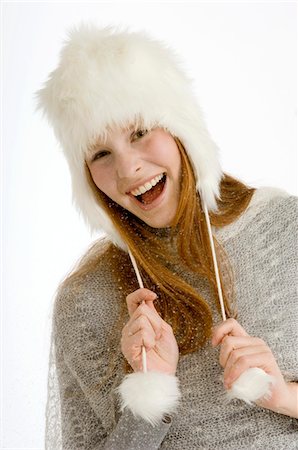 dance studio - Portrait of a young woman wearing a fur hat and smiling Stock Photo - Premium Royalty-Free, Code: 6108-05873587