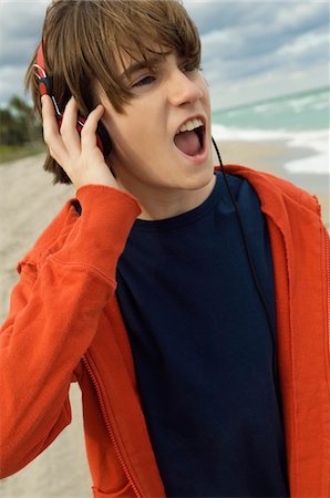 red music - Close-up of a boy listening to headphones Stock Photo - Premium Royalty-Free, Code: 6108-05873686