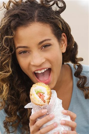 simsearch:6108-05865577,k - Portrait of a girl eating a sandwich Stock Photo - Premium Royalty-Free, Code: 6108-05873694