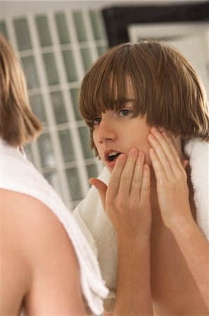 simsearch:6108-05863386,k - Boy examining his face in the bathroom mirror Stock Photo - Premium Royalty-Free, Code: 6108-05873714