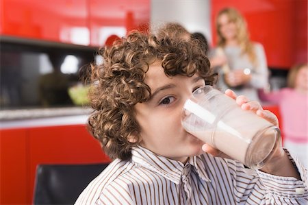simsearch:6108-07969525,k - Portrait of a boy drinking a glass of milk Stock Photo - Premium Royalty-Free, Code: 6108-05873988