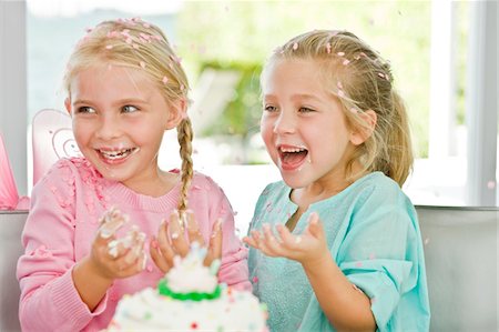 Two girls enjoying a birthday party Stock Photo - Premium Royalty-Free, Code: 6108-05874092