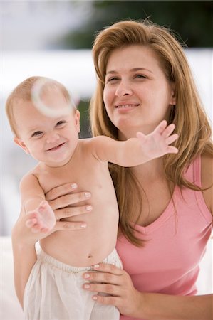 Woman holding her daughter Stock Photo - Premium Royalty-Free, Code: 6108-05874025