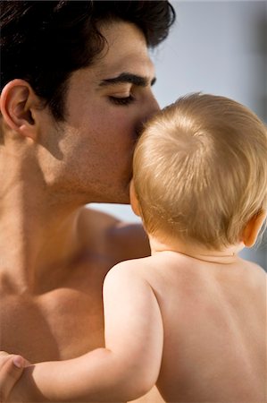 simsearch:6108-05865577,k - Close-up of a man kissing his son Stock Photo - Premium Royalty-Free, Code: 6108-05874037