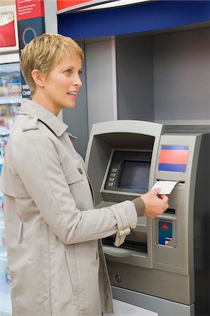 simsearch:6108-05860554,k - Woman receiving a transaction slip from an ATM Stock Photo - Premium Royalty-Free, Code: 6108-05874151