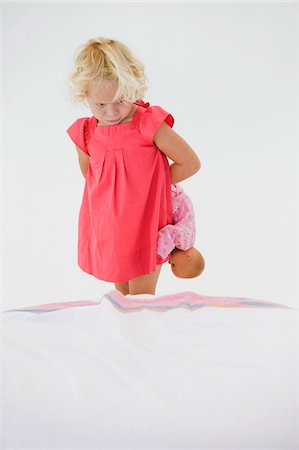 frustrated - Girl holding a doll and looking serious Stock Photo - Premium Royalty-Free, Code: 6108-05874246