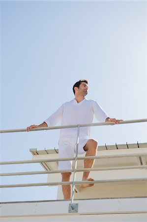 simsearch:6108-05859747,k - Man standing on the beach house Stock Photo - Premium Royalty-Free, Code: 6108-05874318