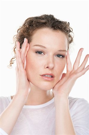 Portrait of a woman rubbing temples Stock Photo - Premium Royalty-Free, Code: 6108-05874814