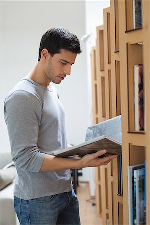 selective - Man choosing a book from a bookshelf Stock Photo - Premium Royalty-Free, Code: 6108-06166001