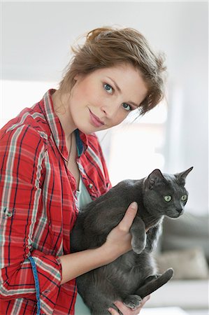 pet owners and their pets - Woman holding a grey cat Stock Photo - Premium Royalty-Free, Code: 6108-06166249