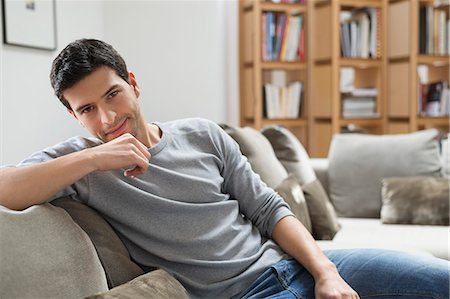 portrait 30s man not woman - Portrait of a man resting on a couch Stock Photo - Premium Royalty-Free, Code: 6108-06166253