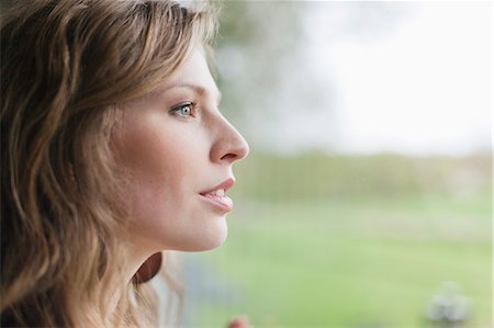face sideview - Close-up of a woman looking through window Stock Photo - Premium Royalty-Free, Code: 6108-06166221