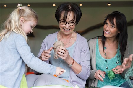 Girl learning knitting with her mother and grandmother Stock Photo - Premium Royalty-Free, Code: 6108-06166358