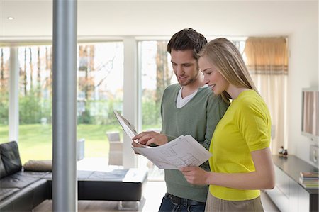 Couple choosing color for their house from a color chart Stock Photo - Premium Royalty-Free, Code: 6108-06166465