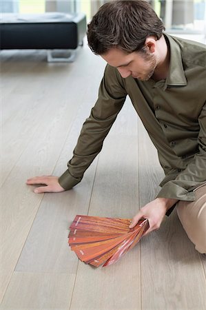 designer (interior, male) - High angle view of a man holding laminated boards Stock Photo - Premium Royalty-Free, Code: 6108-06166487