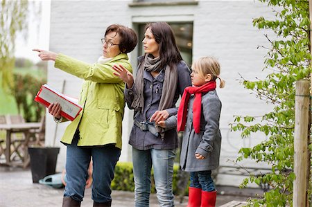 real estate agent - Real estate agent showing woman a house Stock Photo - Premium Royalty-Free, Code: 6108-06166547