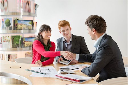 flyer - Real estate agent discussing property documents to his clients Stock Photo - Premium Royalty-Free, Code: 6108-06166575