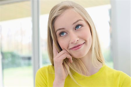 female smirk - Close-up of a woman smiling Stock Photo - Premium Royalty-Free, Code: 6108-06166534