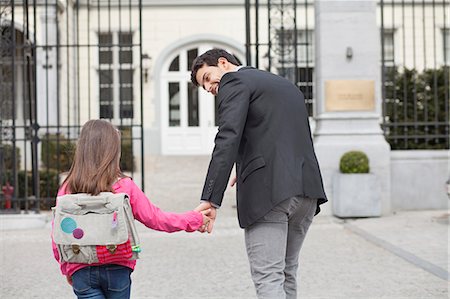 education and back to school - Girl walking towards school with her father Stock Photo - Premium Royalty-Free, Code: 6108-06166836