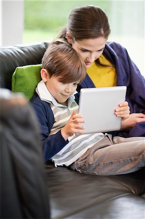 Woman and her son looking at a digital tablet Stock Photo - Premium Royalty-Free, Code: 6108-06166964