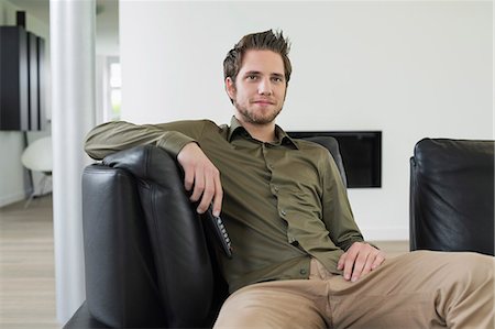 Man watching television Stock Photo - Premium Royalty-Free, Code: 6108-06166971