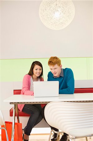 simsearch:6108-06168245,k - Business couple working on a laptop in an office Foto de stock - Sin royalties Premium, Código: 6108-06166974