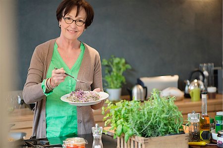 simsearch:6108-06167085,k - Portrait of a woman tasting food Stock Photo - Premium Royalty-Free, Code: 6108-06167062