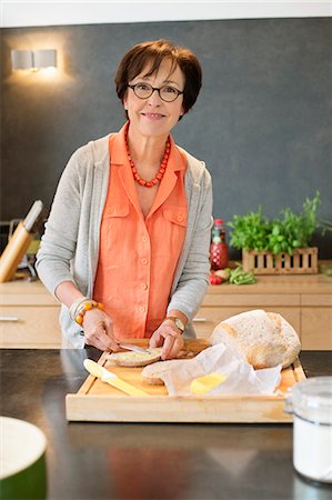 simsearch:6108-06167085,k - Woman applying butter on bread Stock Photo - Premium Royalty-Free, Code: 6108-06167065