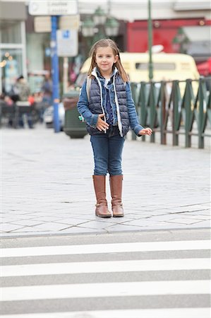 Schoolgirl standing at the roadside Stock Photo - Premium Royalty-Free, Code: 6108-06167011