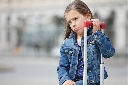 Close-up of a girl with her luggage Stock Photo - Premium Royalty-Free, Code: 6108-06167024